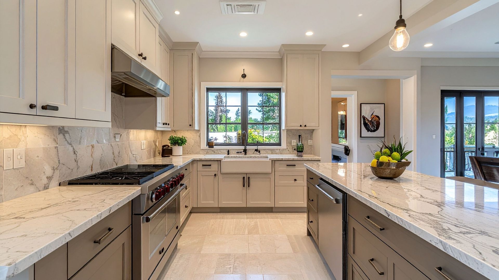 Finished kitchen remodel by J&S Services. Bright white cabinets, marble counters, and natural light.